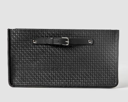 Front view of functional black woven leather storage box with sturdy build and convenient applied handles for stylish organization of space. Modern artisanal accessory for interior design