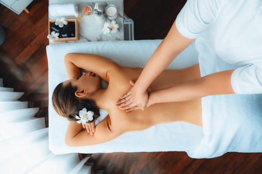 Panorama top view woman customer enjoying relaxing anti-stress spa massage and pampering with beauty skin recreation leisure in day light ambient salon spa at luxury resort or hotel. Quiescent