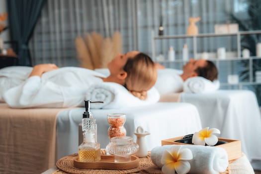 Aromatherapy massage on daylight ambiance or spa salon composition setup with focus decor and spa accessories on blur woman enjoying blissful aroma spa massage in resort or hotel background. Quiescent