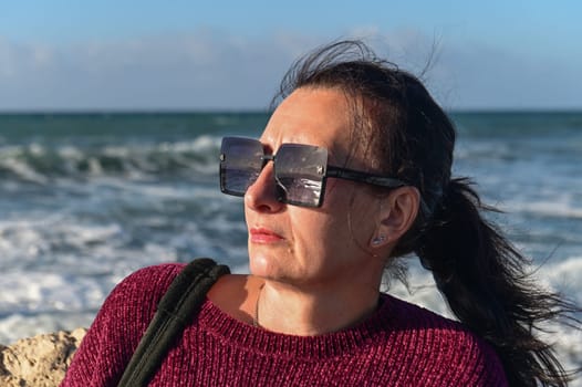 woman on a stone against the background of the sea