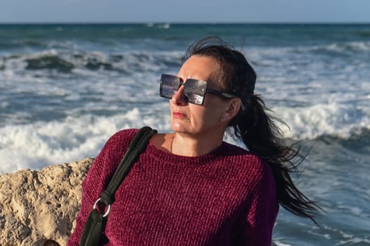 woman on a stone against the background of the sea 2