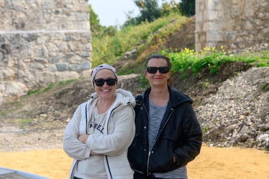 two girlfriends against the background of an old castle