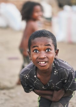 Ranohira, Madagascar - April 29, 2019: Unknown young Malagasy boy posing for camera with funny, surprised like expression - people on Madagascar are poor but cheerful, especially children