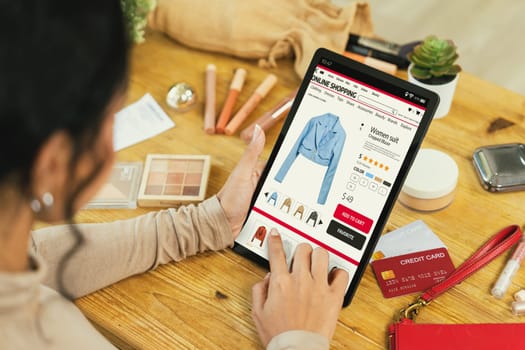 Woman shopping online on internet marketplace browsing for sale items for modern lifestyle and use credit card for online payment from wallet protected by crucial cyber security software