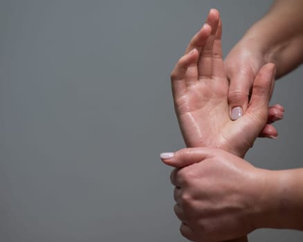 The masseuse massages the client's palms. Close-up of hands at a spa treatment. Copy space