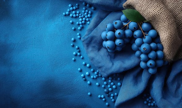 Scattered blueberry on burlap and blue background. Selective soft focus