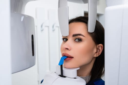 X ray examination of teeth of young woman in dentist office