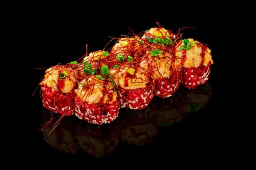 Exquisite red rice sushi rolls crowned with seared cheese caps with scallops, adorned with togarashi threads, green onion, and drizzle of unagi sauce, presented on reflective black surface