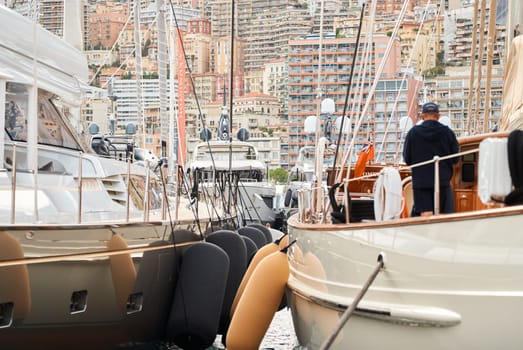 Monaco, Monte Carlo, 29 September 2022 - Invited wealthy clients inspect mega yachts at the largest fair exhibition in the world yacht show MYS, port Hercules, yacht brokers, sunny weather. High quality photo