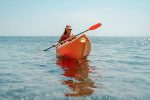 Kayak sea woman. Happy attractive woman with long hair in red swimsuit, swimming on kayak. Summer holiday vacation and travel concept