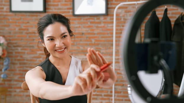 Woman influencer shoot live streaming vlog video review vivancy makeup social media or blog. Happy young girl with cosmetics studio lighting for marketing recording session broadcasting online.