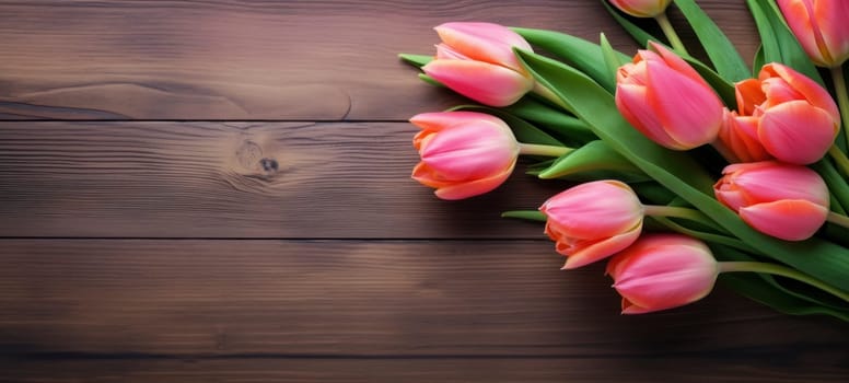 A bouquet of pink tulips arranged elegantly on a polished wooden surface, emphasizing contrast and natural beauty.