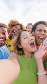 Chinese woman taking selfie with multiethnic friends outdoors. Vertical shoot