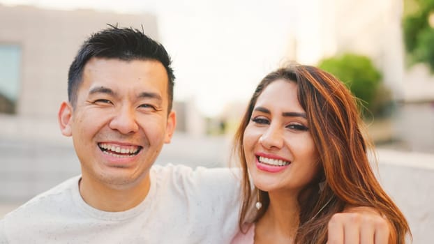 Multiethnic couple on the street looking at camera