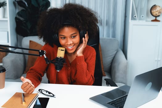 Host channel of beautiful African woman influencer talking with new listeners in broadcast studio. Time slot of life coach consultant on live social media online. Concept of giving advice. Tastemaker.