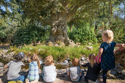 KAATSHEUVEL, NETHERLANDS - APRIL 19, 2019: An old tree tells children legends and fairy tales in a Park Efteling