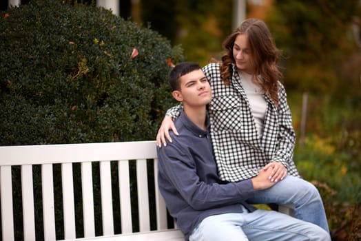 lovely young couple kissing outdoors in autumn. Loving couple walking in nature. Autumn mood. Happy man and woman hugging and kissing in autumn. Love. Fashionable couple outdoors. Fashion, people and lifestyle. Stylish couple in autumn outfit.