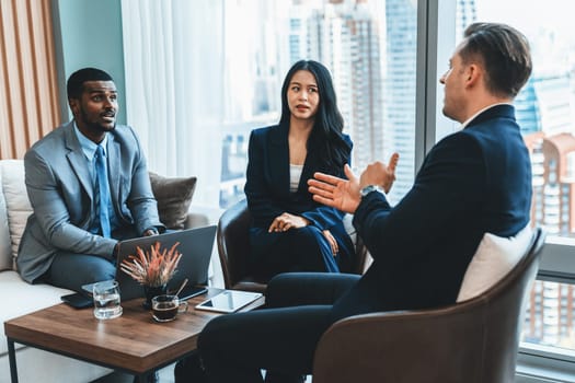 African businessman present start up project to expert investor. Group of multicultural business team solving problems, discussing business idea with skyscraper at modern business lounge. Ornamented