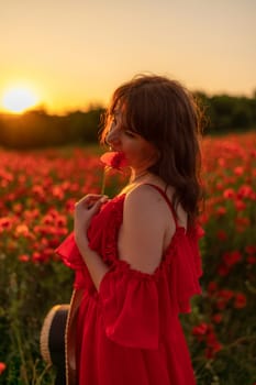 Woman poppy field red dress sunset. Happy woman in a long red dress in a beautiful large poppy field. Blond stands with her back posing on a large field of red poppies.