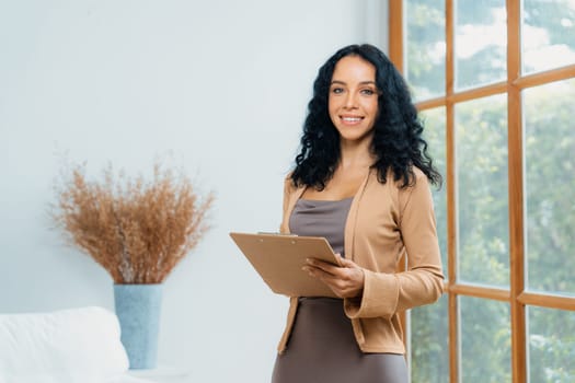 Psychologist woman in clinic office professional portrait with friendly smile feeling inviting for patient to visit the psychologist. The experienced and confident psychologist is crucial specialist