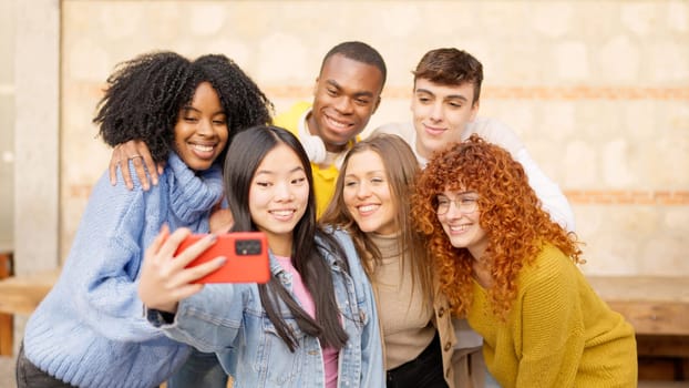 Chinese girl taking a selfie with diverse friends outdoors