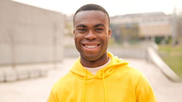 An african young man standing outdoors and smiling