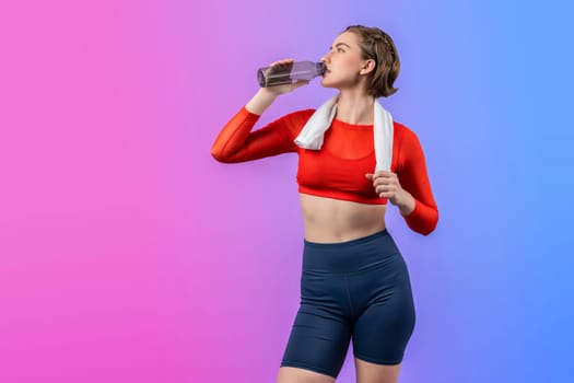 Full body length gaiety shot athletic and sporty young woman with towel and drinking water in fitness exercise posture on isolated background. Healthy active and body care lifestyle.