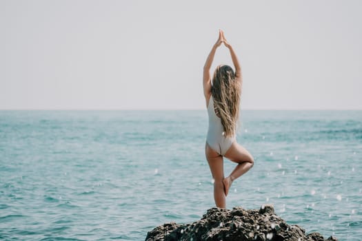 Silhouette mother and daughter doing yoga at beach. Woman on yoga mat in beach meditation, mental health training or mind wellness by ocean, sea