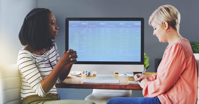 Business women, communication and feedback by computer screen in office, diversity and talking or writing on accounting. Workplace, productivity or finance team by desktop or collaboration on project.