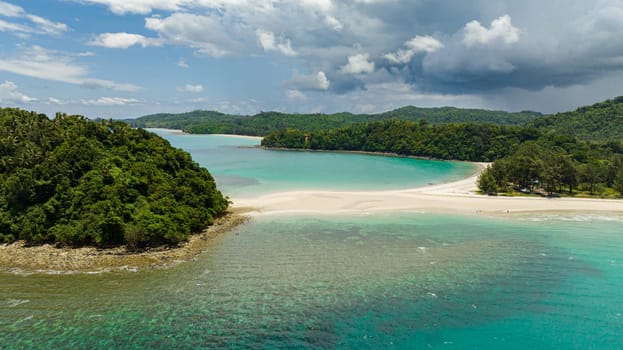 Aerial view of beautiful sandy beach and tropical island. Tropical landscape. Kelambu Beach. Borneo, Malaysia.