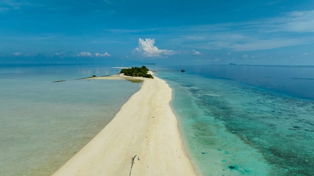 Sandy tropical island with a beautiful beach surrounded by a coral reef.Timba Timba islet. Tun Sakaran Marine Park. Borneo, Sabah, Malaysia.