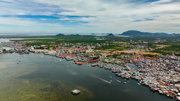 Aerial drone of traditional stilt houses of poor people in the town of Semporna. Borneo, Sabah, Malaysia.