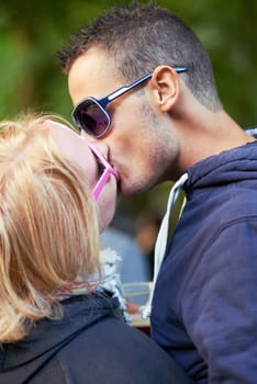 Kissing, fun and outdoor with couple, love and excitement with happiness and marriage with weekend break. People, culture and man with woman or romance with relationship and summer with vacation.
