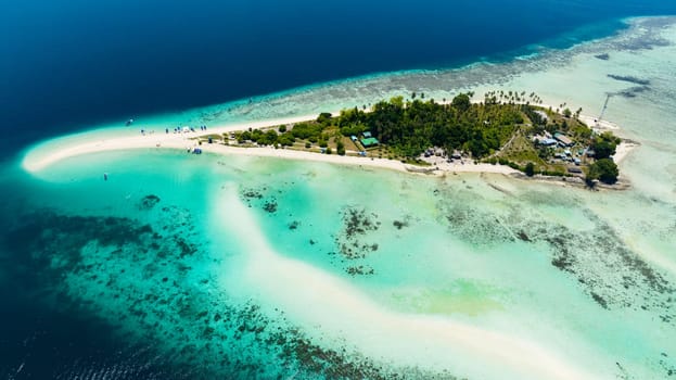 A beautiful Sibuan island with a beach and a coral atoll. Tun Sakaran Marine Park. Borneo, Sabah, Malaysia.