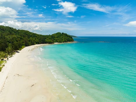 Wide sandy beach with ocean surf and waves. Kelambu Beach. Borneo, Malaysia.