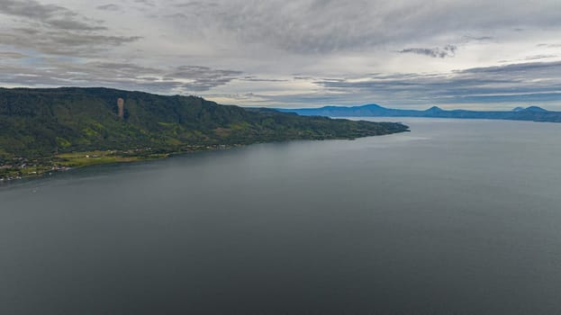 Aerial view of Lake Toba and the coast of Samosir Island. Tropical landscape. Sumatra, Indonesia.