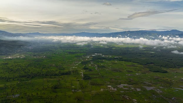 Aerial drone of countryside with farmland and rice fields. Sumatra, Indonesia.