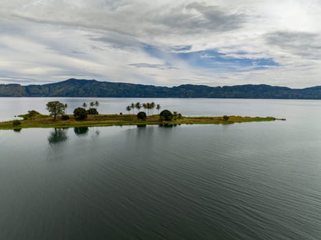 Top view of lake Toba is a large natural lake and and an island with palm trees. Samosir, Pulau Toba. Sumatra, Indonesia.