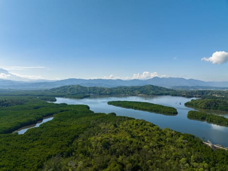 Bay with mangroves against the backdrop of mountains with tropical vegetation. Borneo, Malaysia.