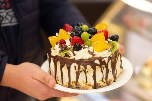 Modern homemade chocolate cake with fresh berries, closeup. High quality photo