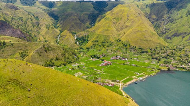 Aerial drone of Farmland in a mountain valley on Lake Toba. Sumatra, Indonesia.