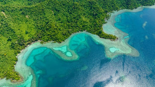 Lagoon with turquoise water in the bay of a tropical island. Borneo, Sabah, Malaysia.