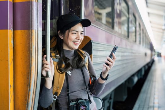 Woman using mobile phone while travel by train. travel concept.