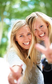 Peace, hands and women portrait in a park for fun, adventure or bonding outdoor together. V, sign or face of friends in a forest with freedom, travel and journey, excited and enjoying weekend reunion.