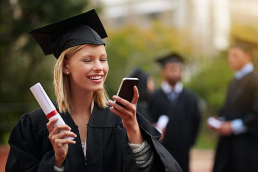 Graduation, certificate and phone with student woman outdoor on campus for university or college event. Mobile, communication and smile with young graduate at school for education or scholarship.