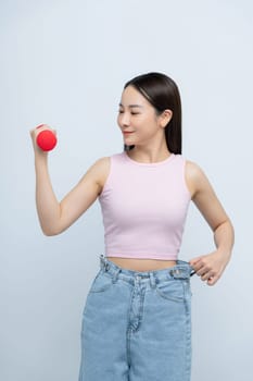 Woman lifting dumbbell in oversized jeans unwearable