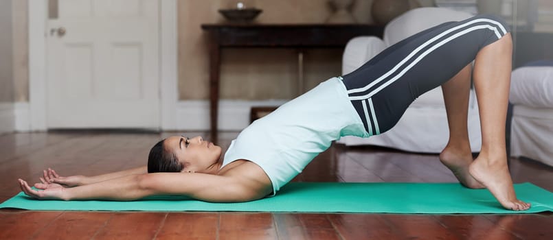 Yoga, stretching and woman on floor for balance in home for training, exercise and healthy body. Pilates, house workout and person in yogi pose for wellness, fitness and warm up in living room.