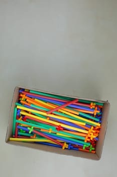 Flexible construction set made of plastic tubes with special connectors in box on the table