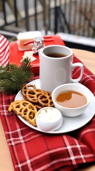 A plate of pretzels and a cup of coffee on a table