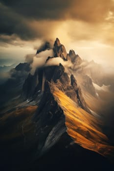 A mountain covered in clouds and yellow grass